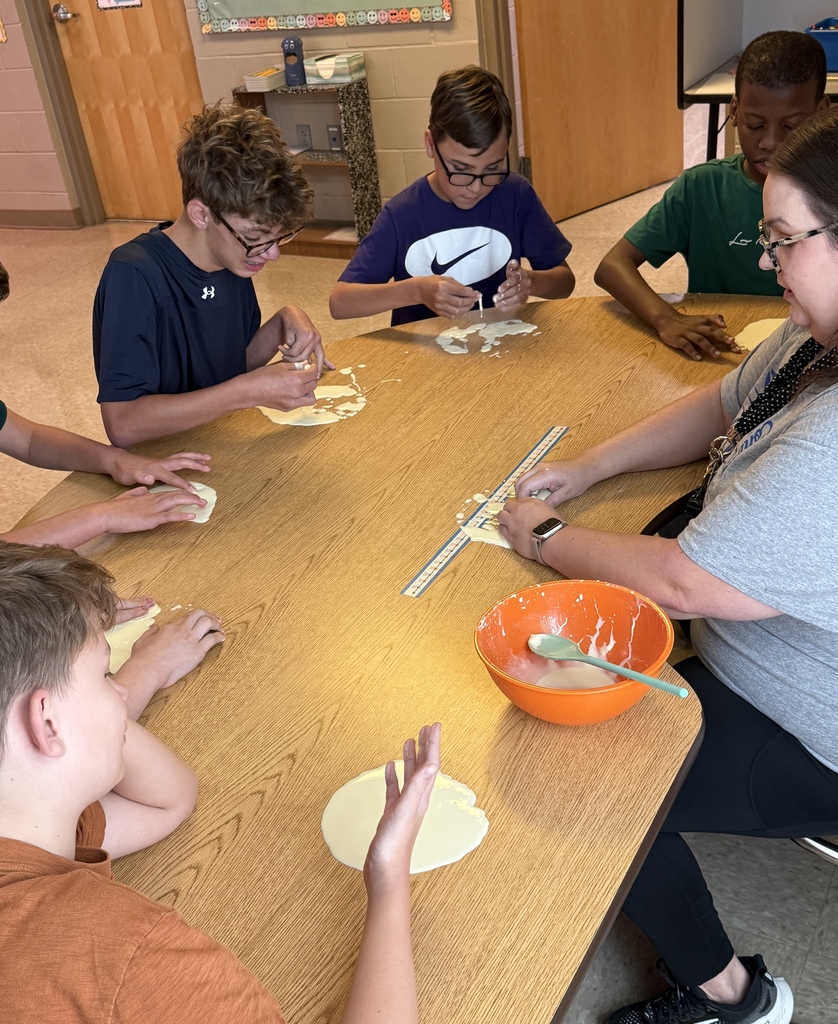 Students with mixture on table