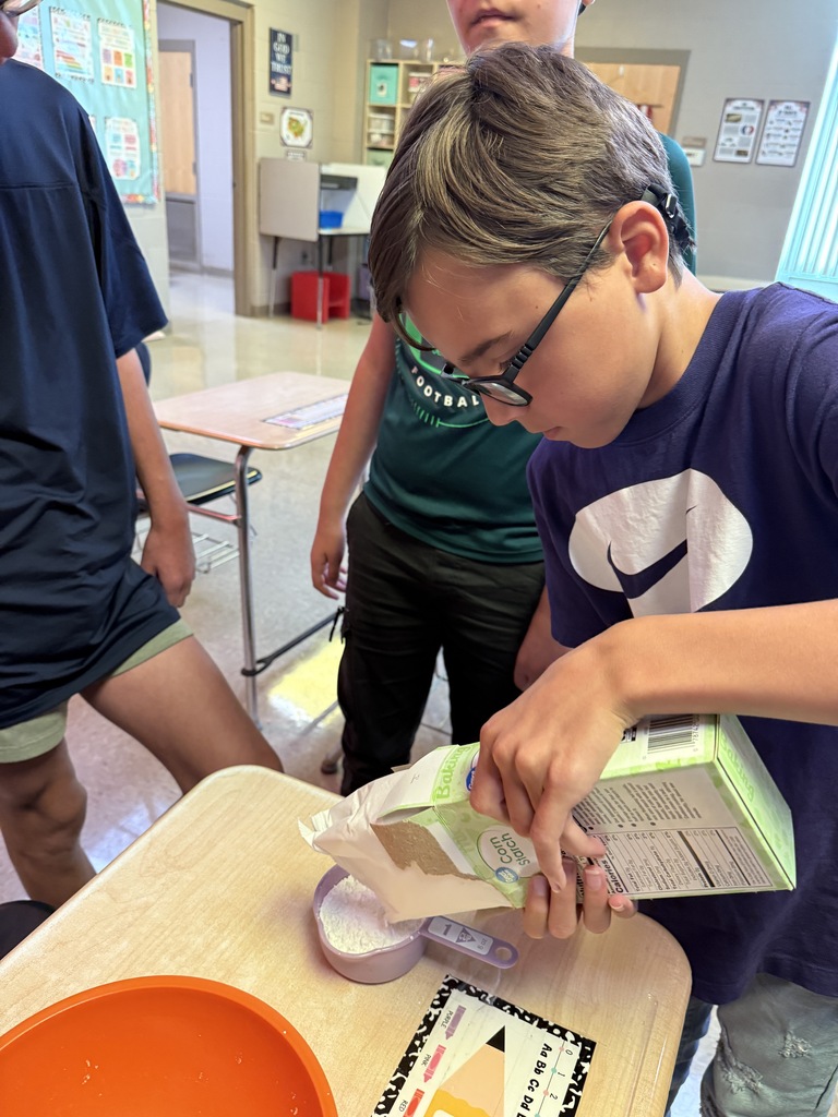 Student pouring cornstarch into bowl