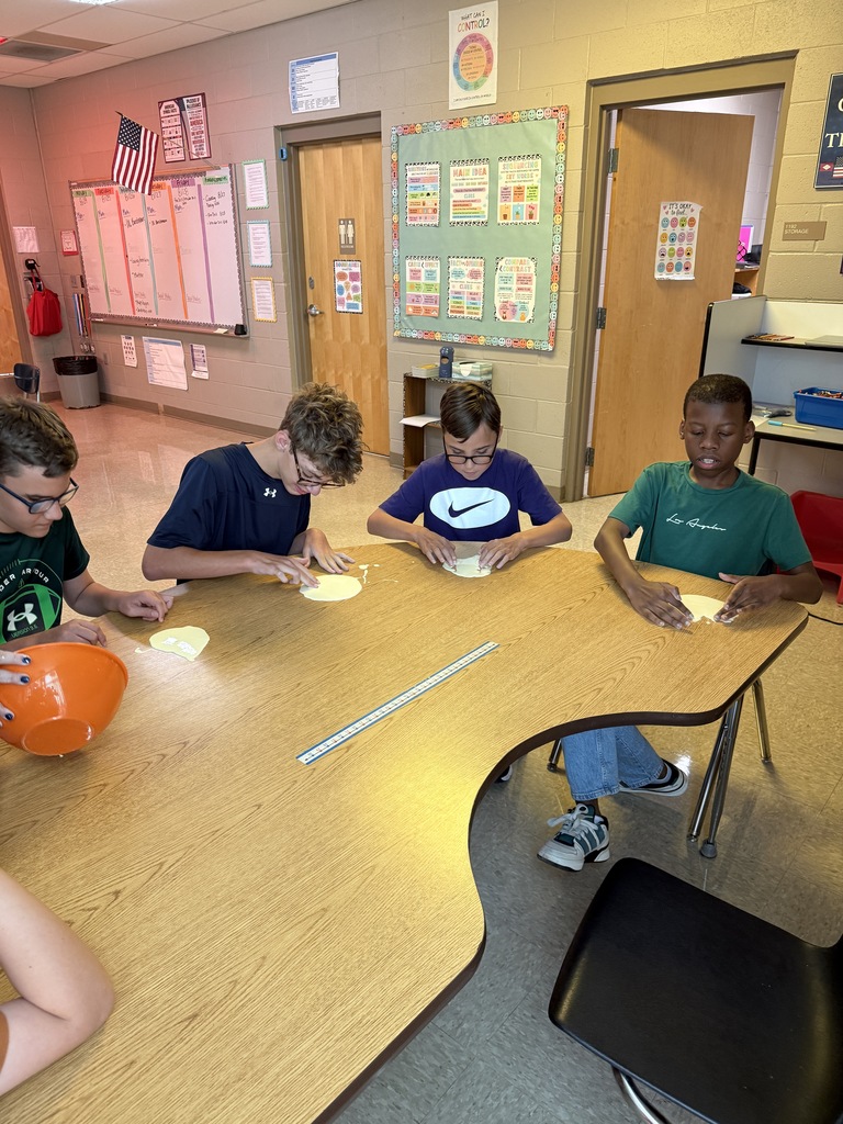 Students with mixture on table