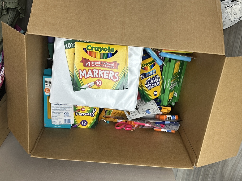 Box of random school supplies donated by Planet Fitness