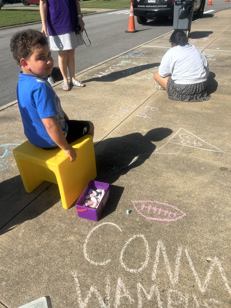student doing sidewalk chalk