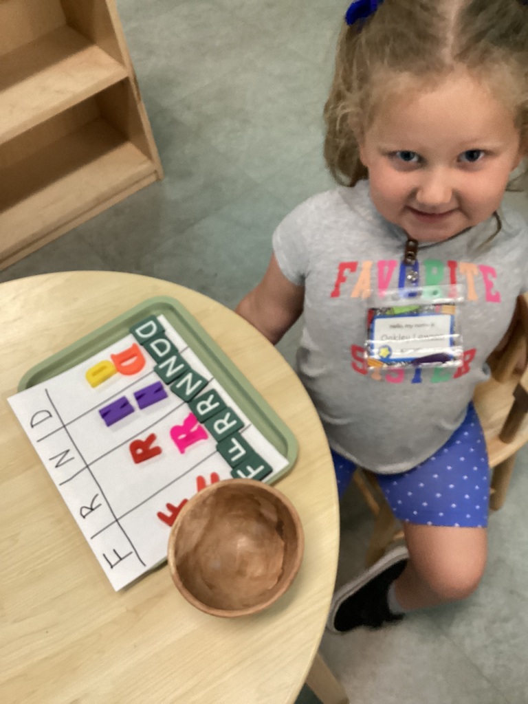 child sorting letters in the corresponding row