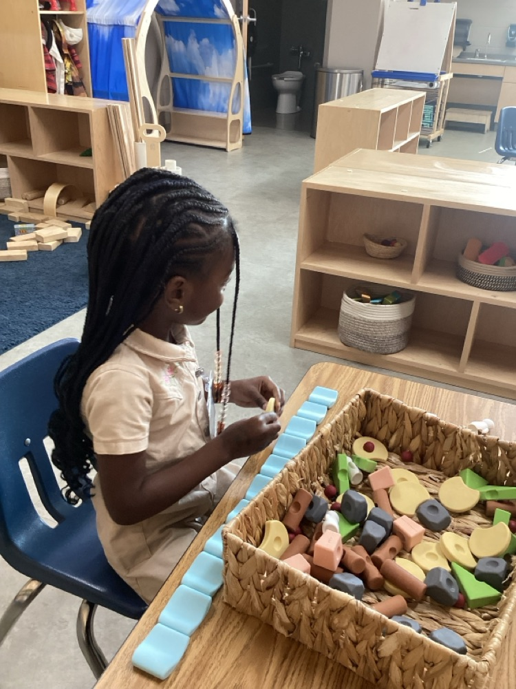 children collaborating to create using loose parts