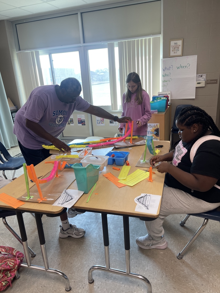 Mr. Foster assists students making 3D "Plot Roller Coasters" to map out story elements.