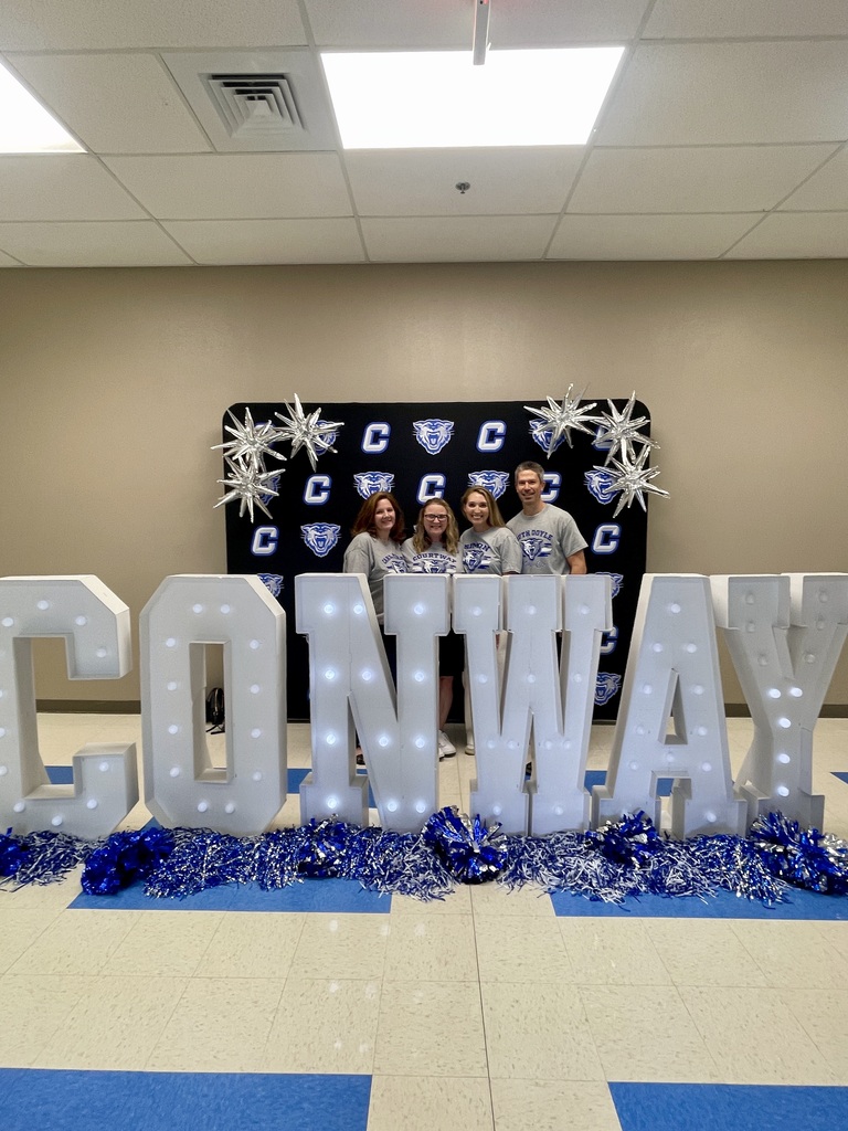 Instructional Coaches posing behind CONWAY letters