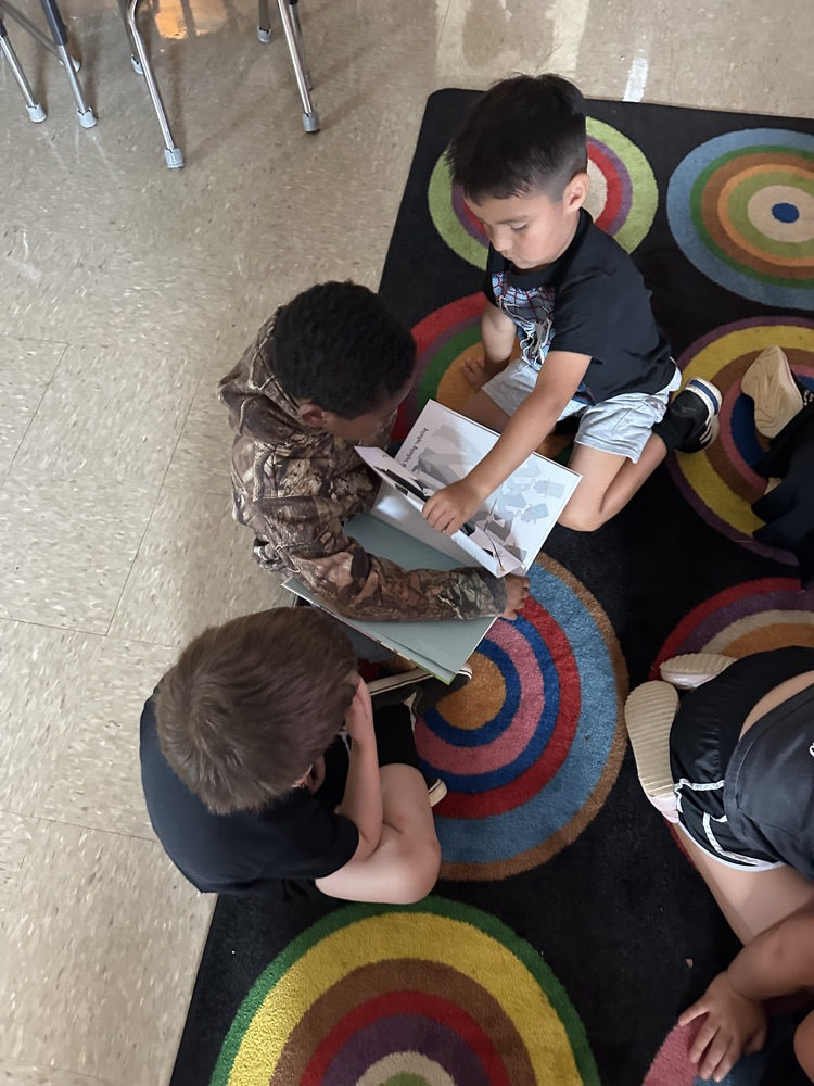 kids reading a book. 