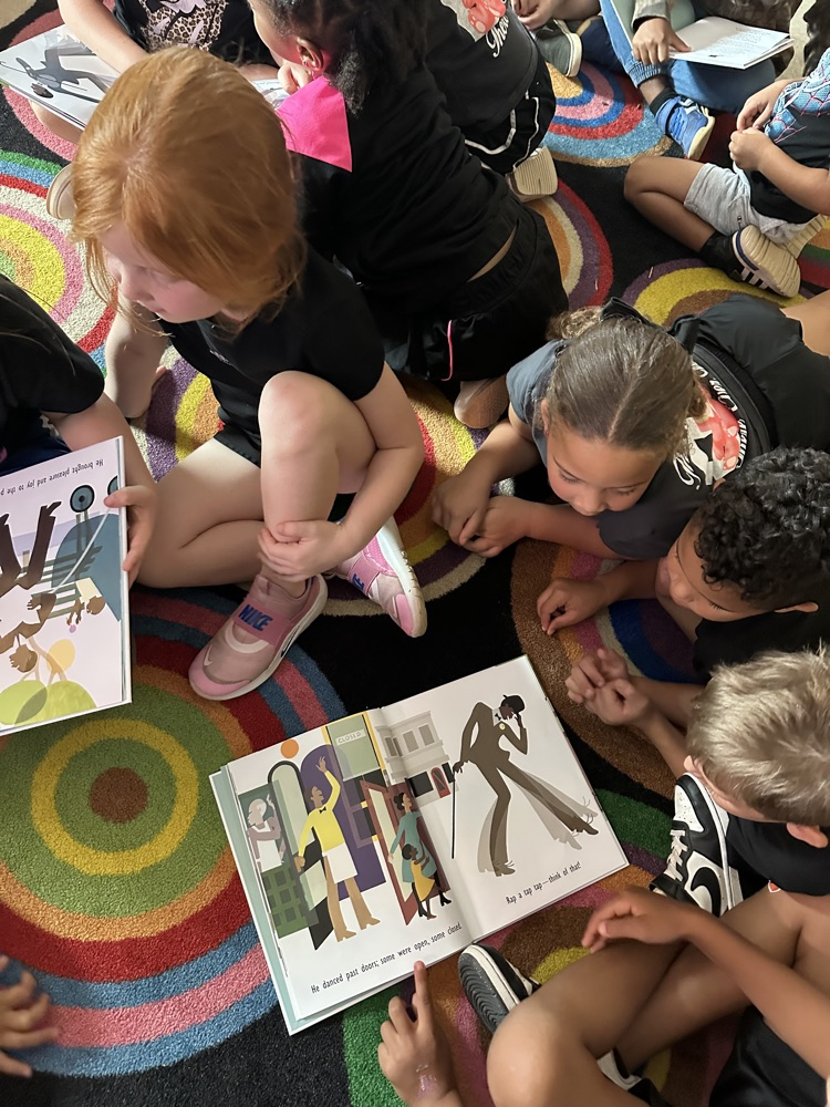 kids reading a book. 