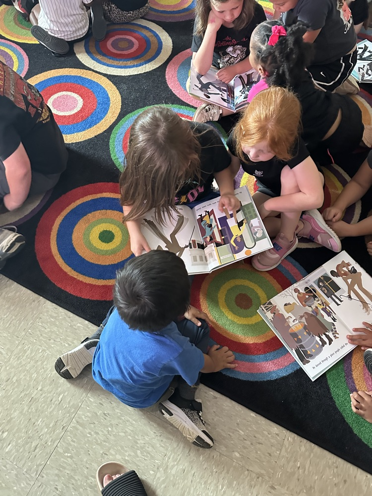 kids reading a book. 