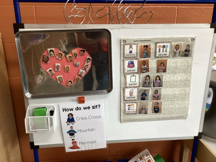 wish well board that shows who is in attendance, job board, and visuals that show ways to sit on carpet, 