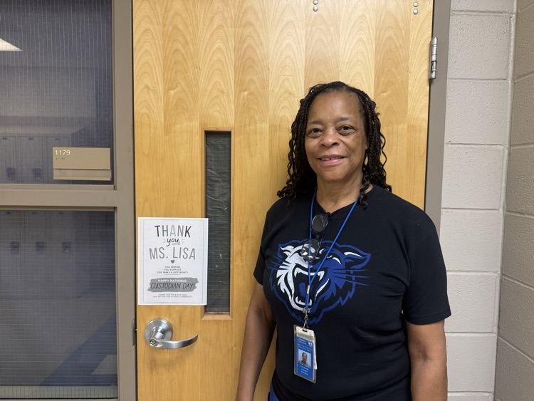 Ms. Lisa standing next to a sign that says Thank You!