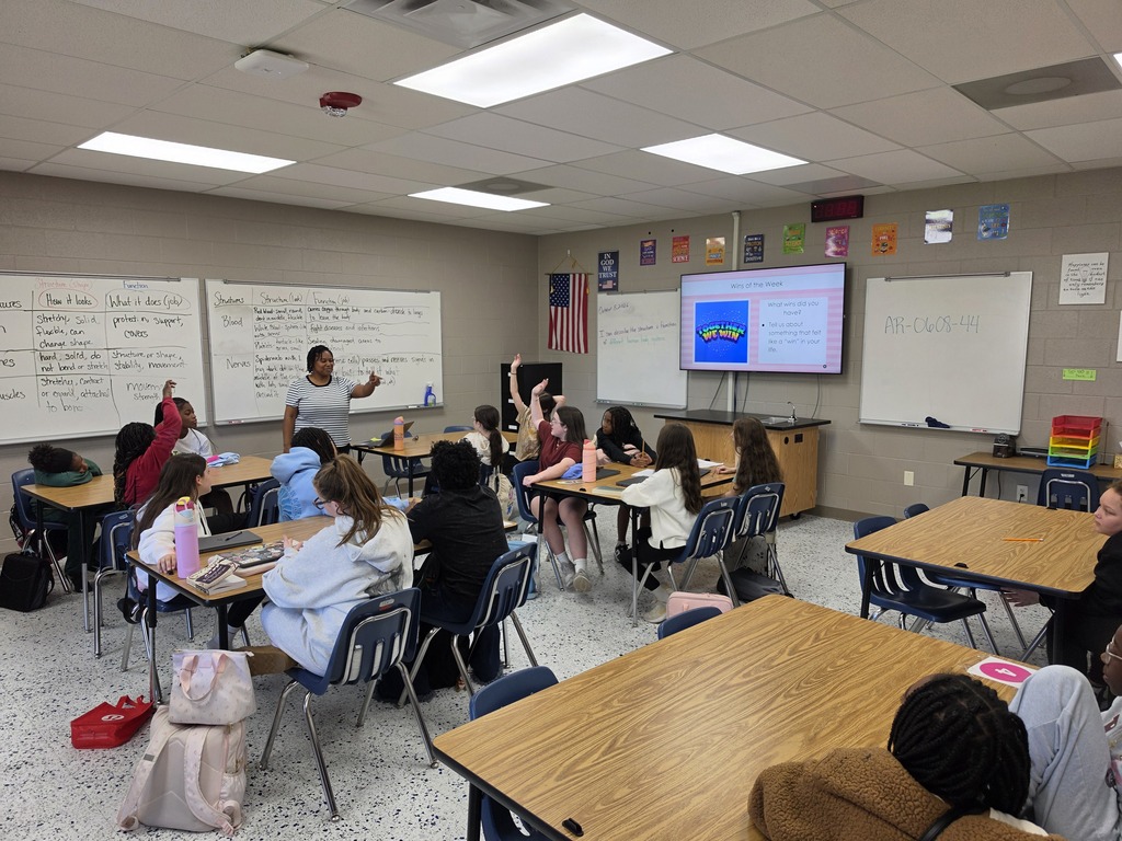 Mrs. King calling on a student in class. She is standing. Students are sitting