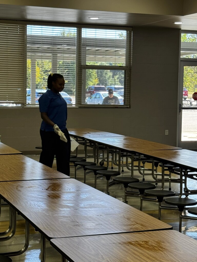 Food Service Worker wiping tables