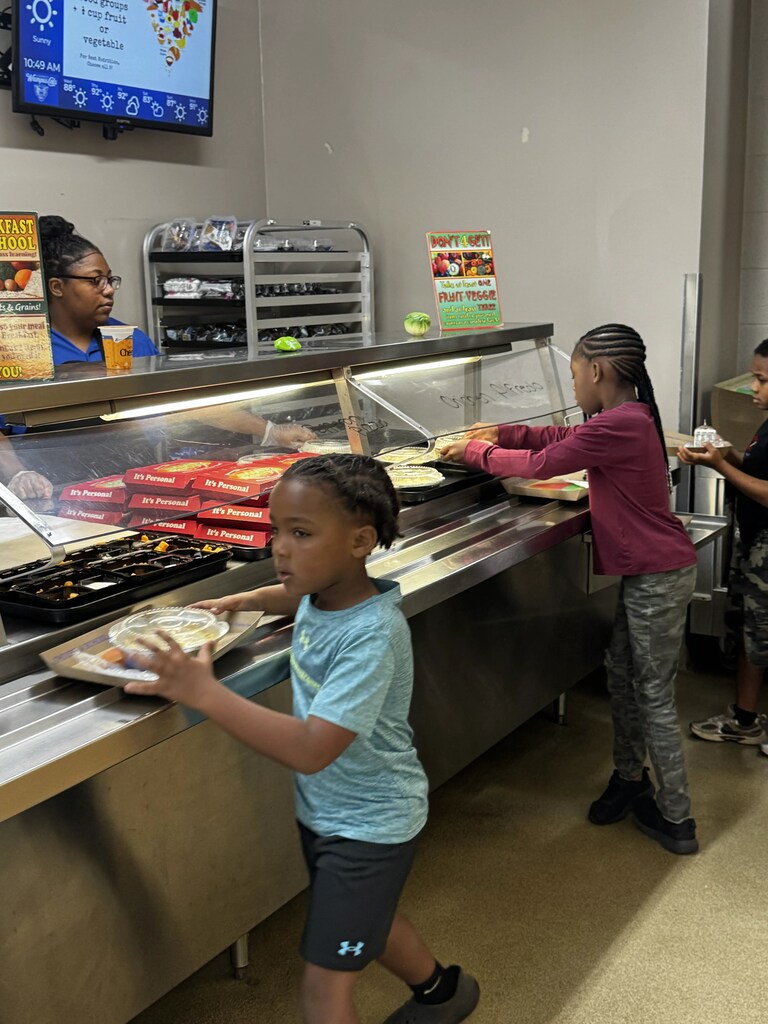 Food Service Worker prepping lunch, serving lunch.