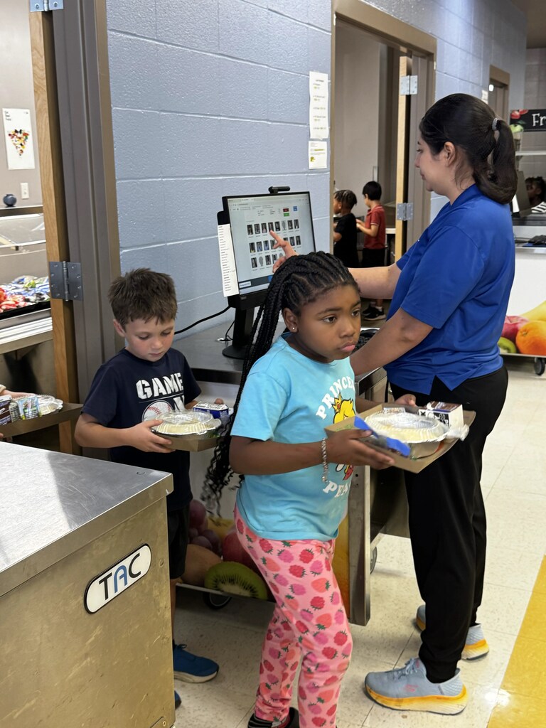 Food Service Worker ringing up students for lunch
