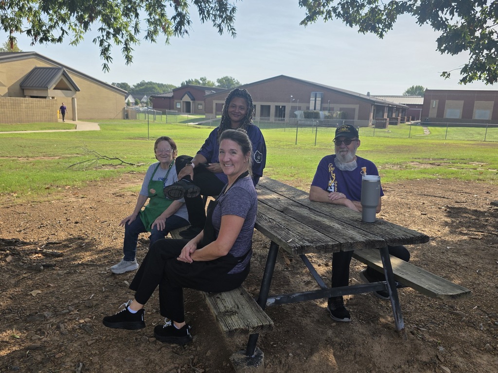 Food service workers smiling at camera at picnic table
