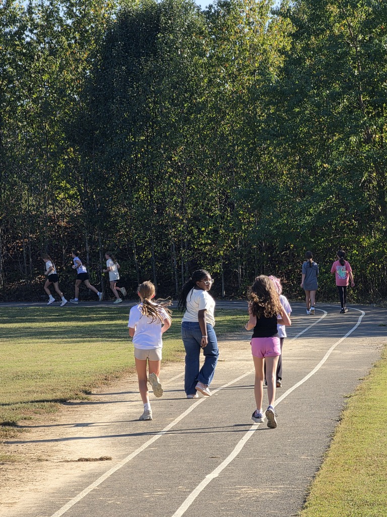 girls running on the track behind carl stuart