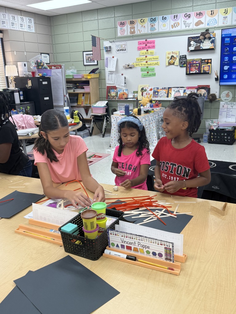 middle school student helping 2 elementary students