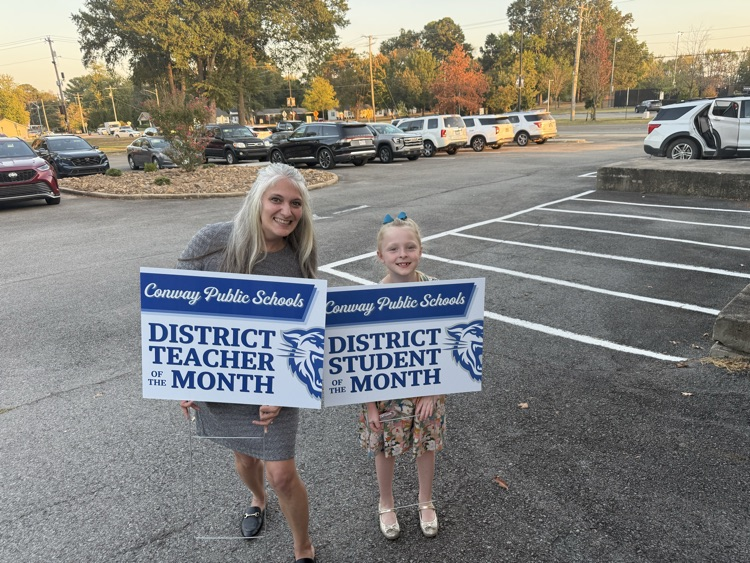 Stella and Ms. Wahrer with their yard signs