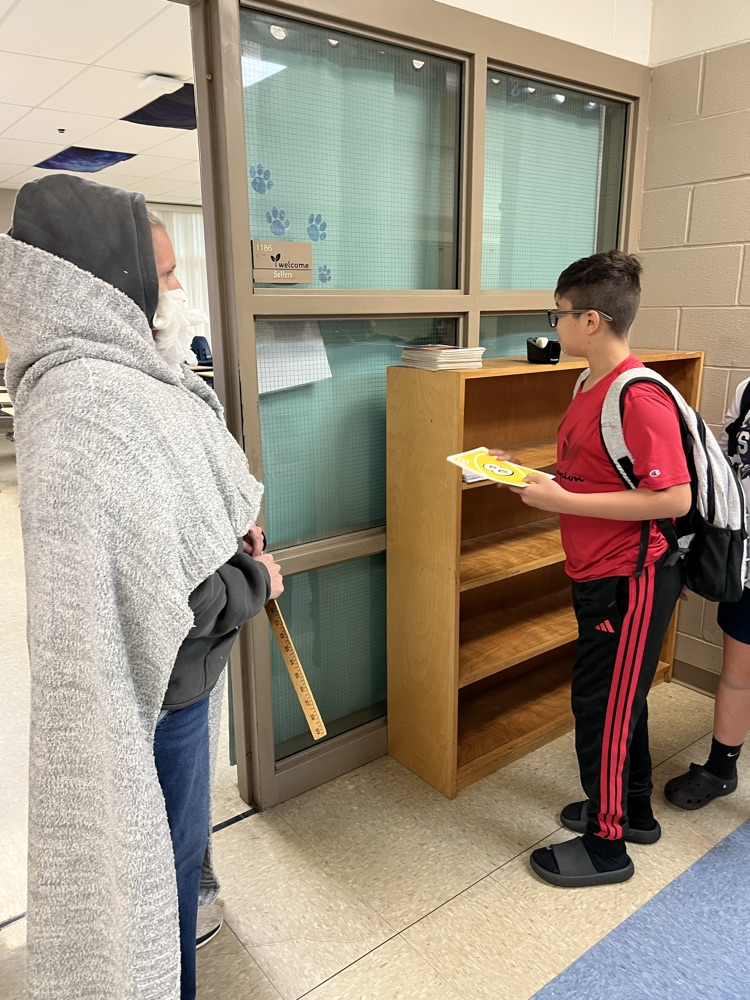 Student drawing an UNO card to enter class