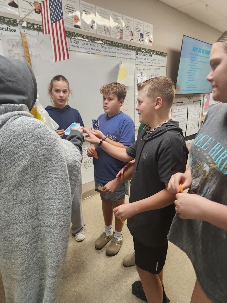 Students drawing UNO cards to leave class