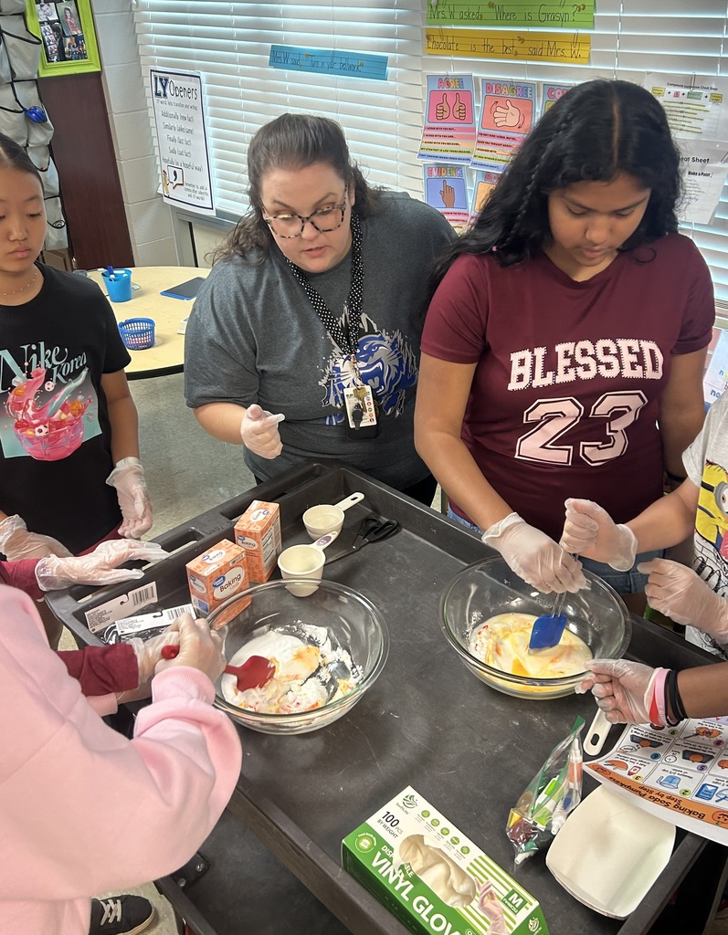 Students and teachers mixing ingredients