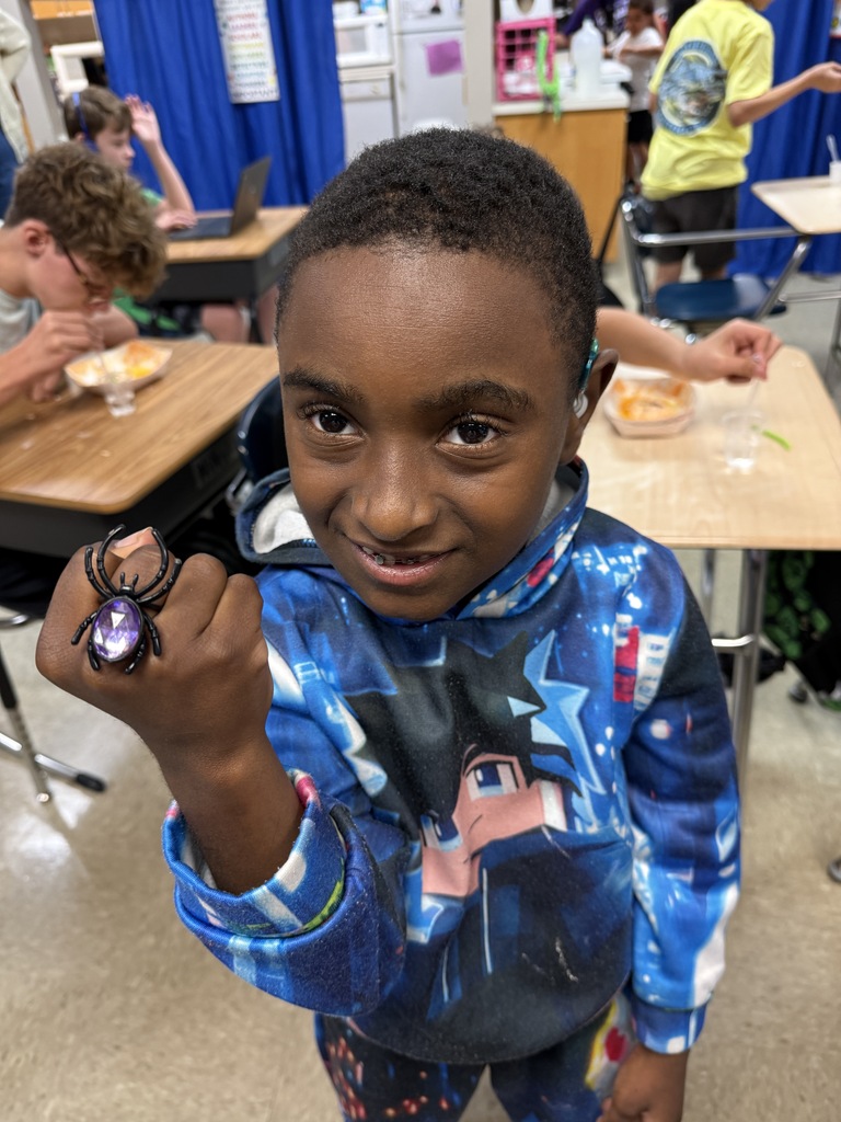 Student smiling and showing off a Halloween spider ring