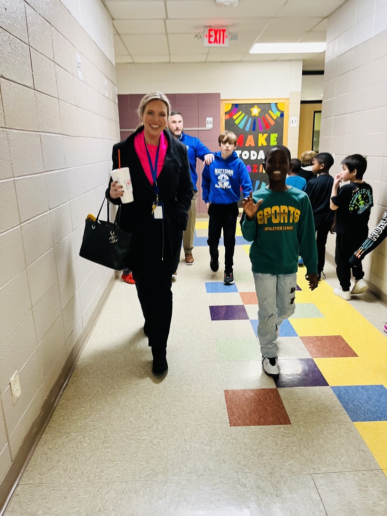 District leader and students walking down the hall