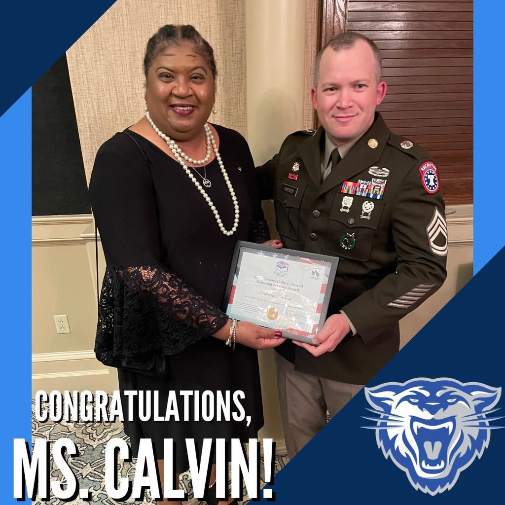 varying shades of blue.  Wampus cat in the bottom right.  Congratulations Ms. Calvin in the bottom left.  Image of Ms. Calvin and the award presenter.