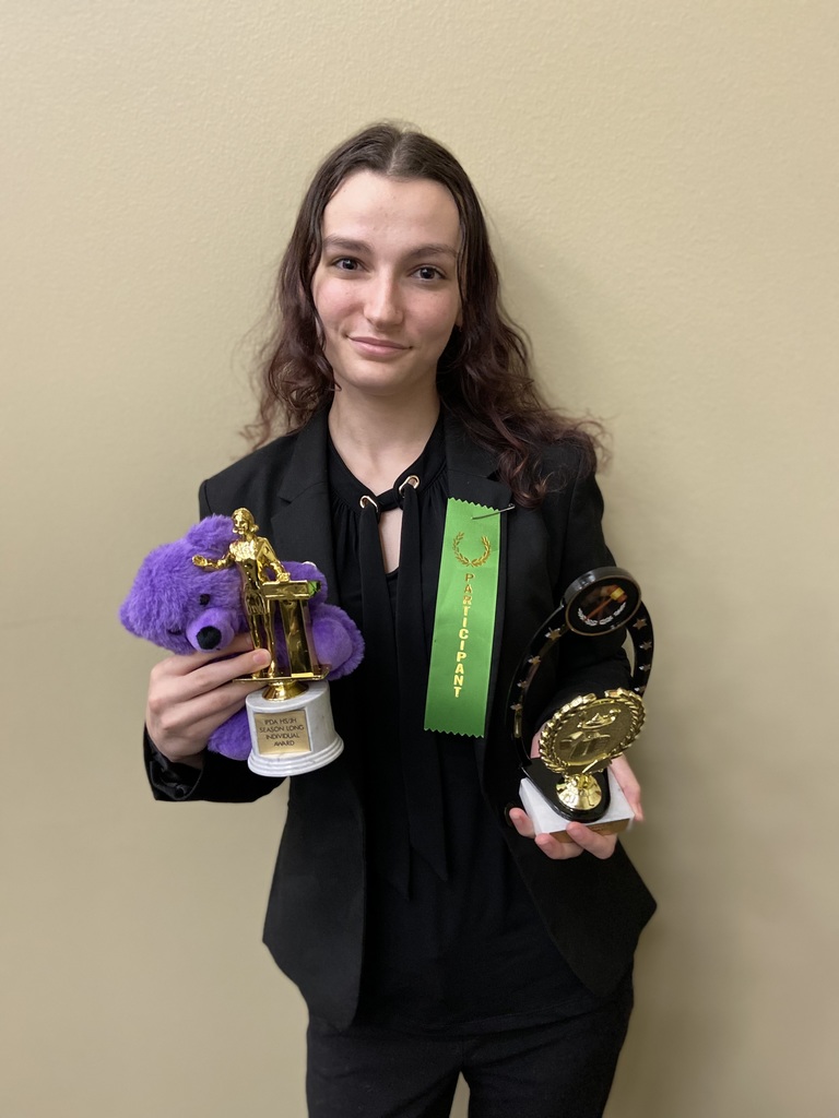 Image of student posing with awards.