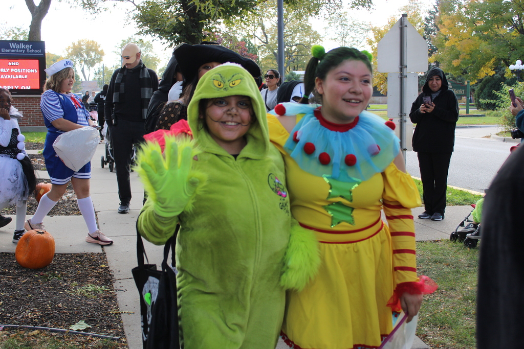 girls in grinch and clown costume
