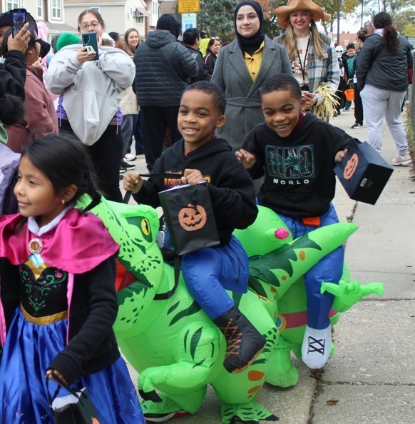 two boys in dinosaur custumes