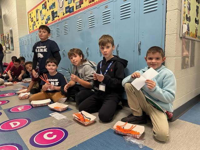 students doing craft in hallway