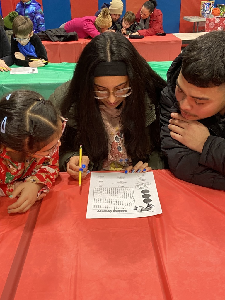 girl, woman, and man playing a word search game