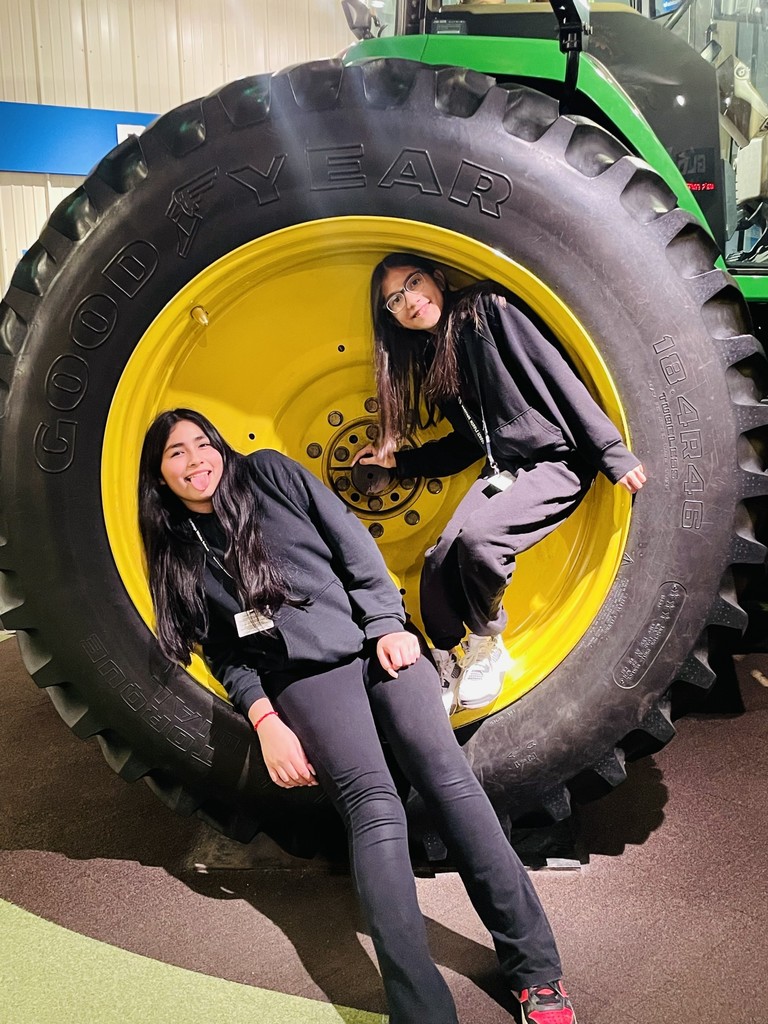 two girl students in a tractor tire
