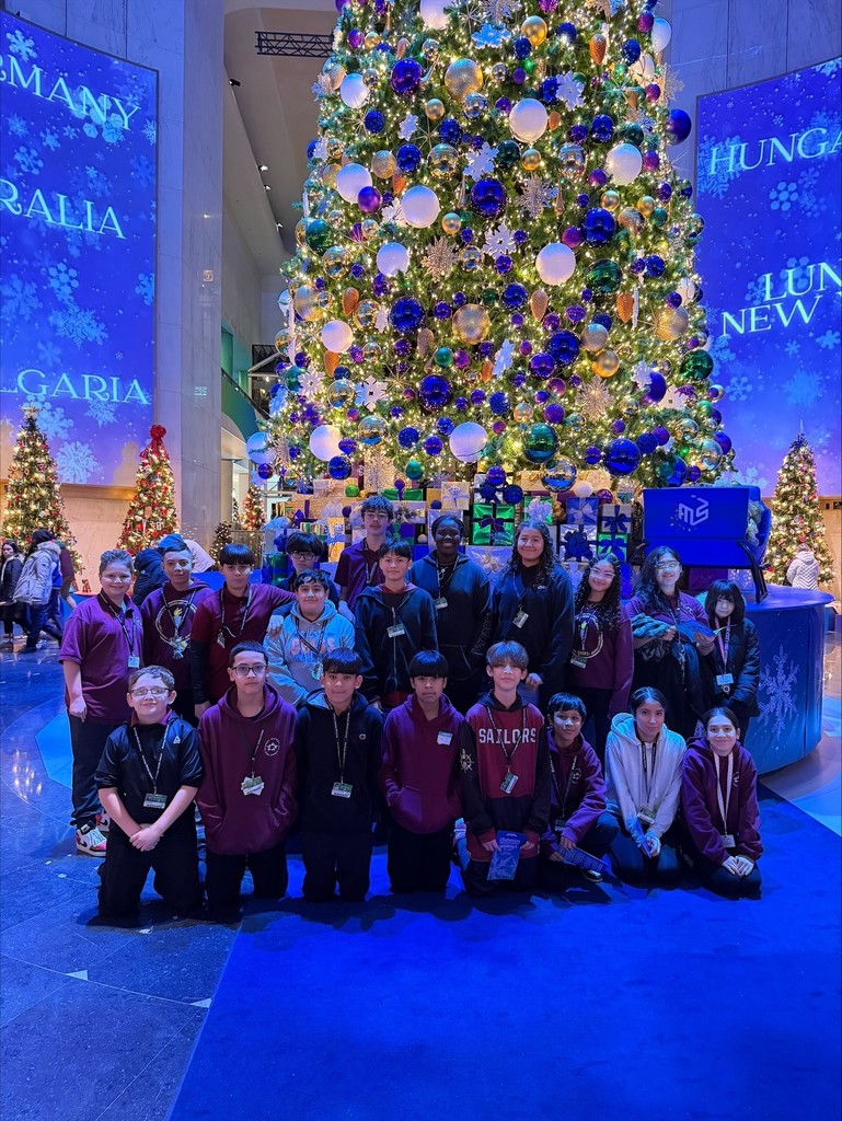 students in front of Christmas tree