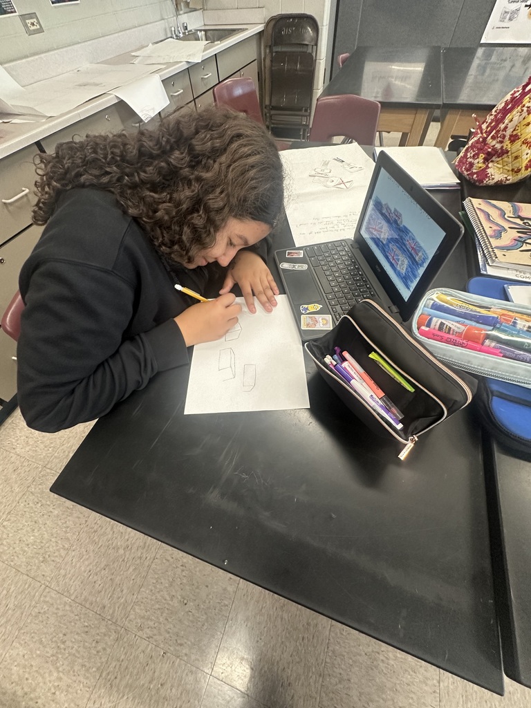 a girl writing down a diagram on paper