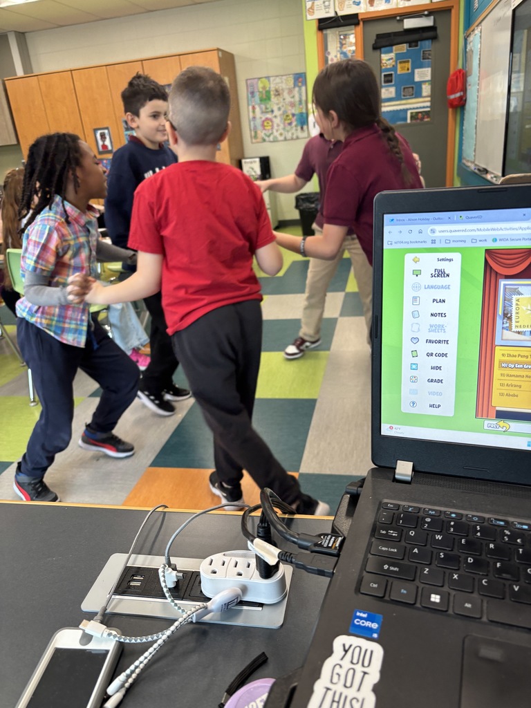 kids spinning in a circle in a classroom