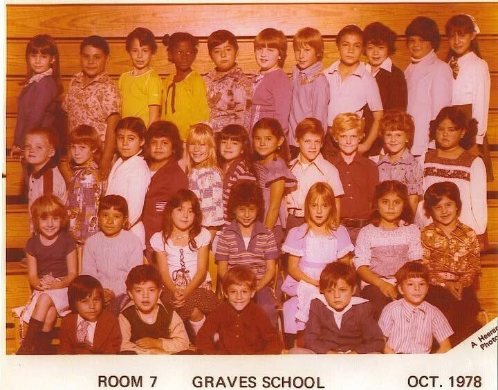 Vintage class portrait of diverse children in four rows before a wood-paneled wall, labeled “Room 7, Graves School, Oct. 1978”; warm, nostalgic tone.