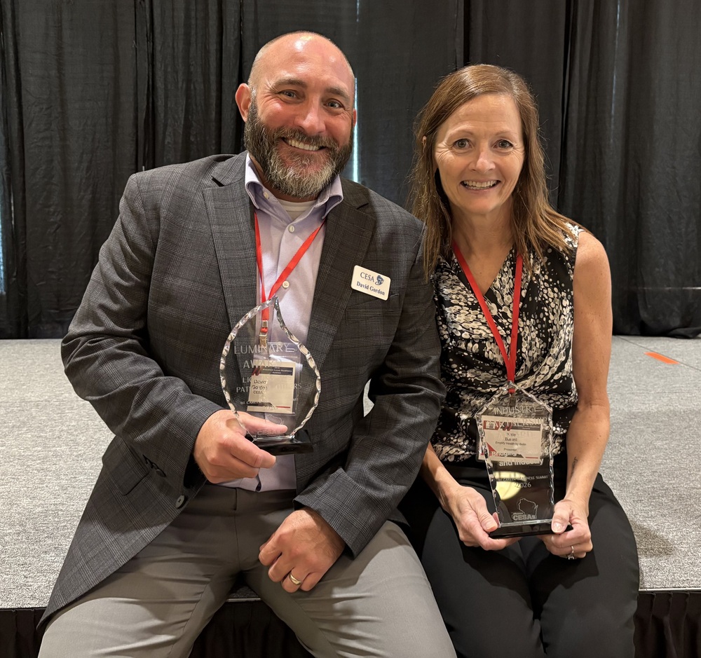 David Gordon and Kate Bartell holding Awards