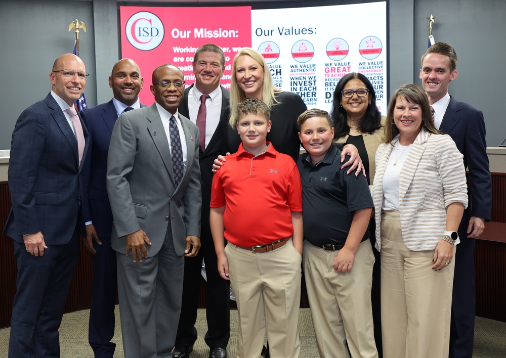 Photo of Dr. Leanne Shivers with her family and CISD Trustees