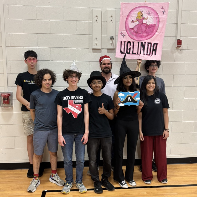 Picture of teenagers posing with an award for school.