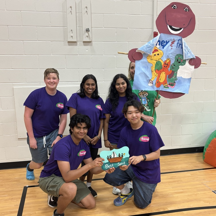Picture of teenagers posing with an award for school.