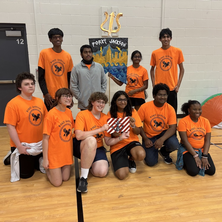Picture of teenagers posing with an award for school.