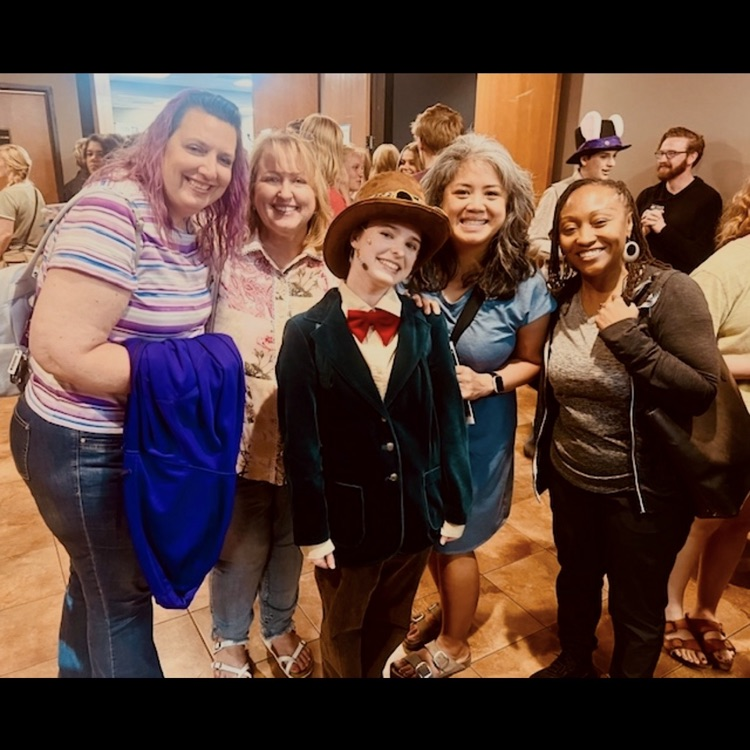 teachers posing for a picture with an actor.