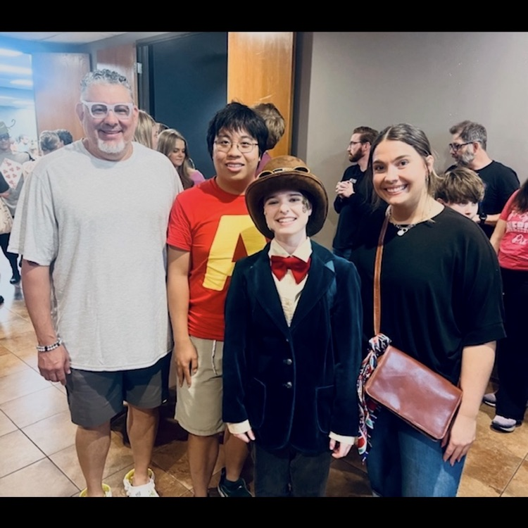 teachers posing for a picture with an actor