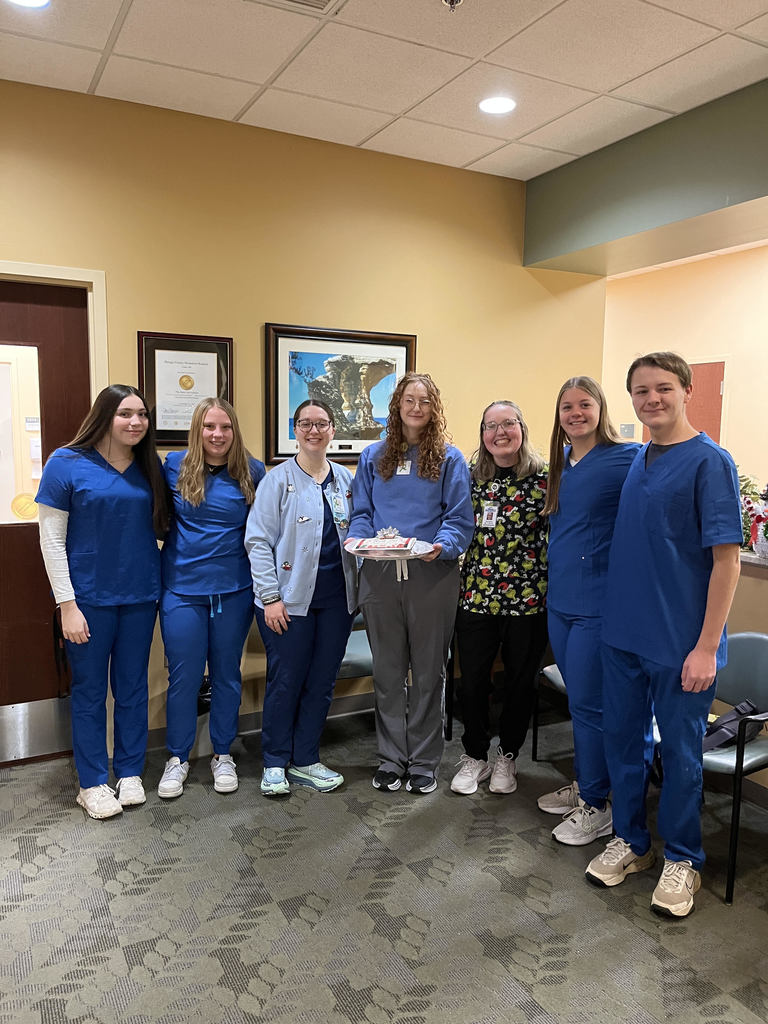 Students Dayonna Picard, McKayla Kemppainen, Stella Makela-Sweeney, and Ivan Johston with healthcare professionals from the BCMH laboratory, including a former CTE Health Careers student Summer Rice (wearing the Grinch scrub top). 