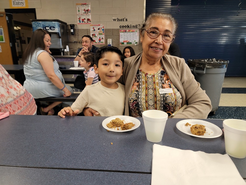 A grandmother and grandson at a cafeteria table