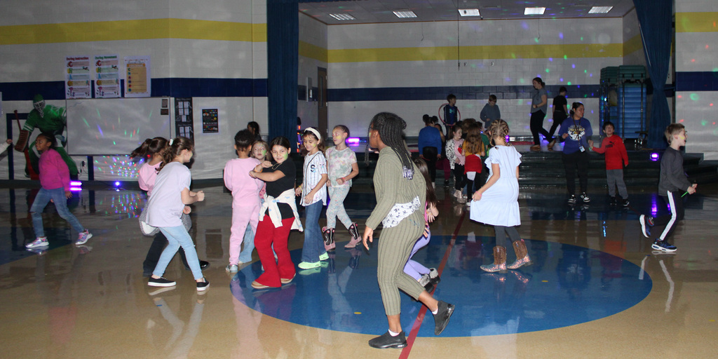 A group of students dancing in a gym