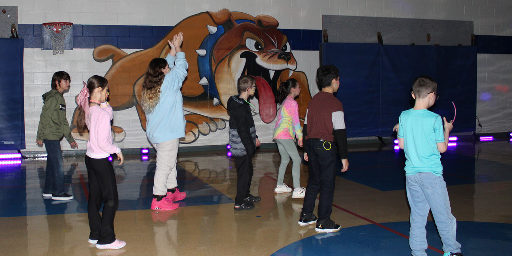 A group of students dancing in a gym