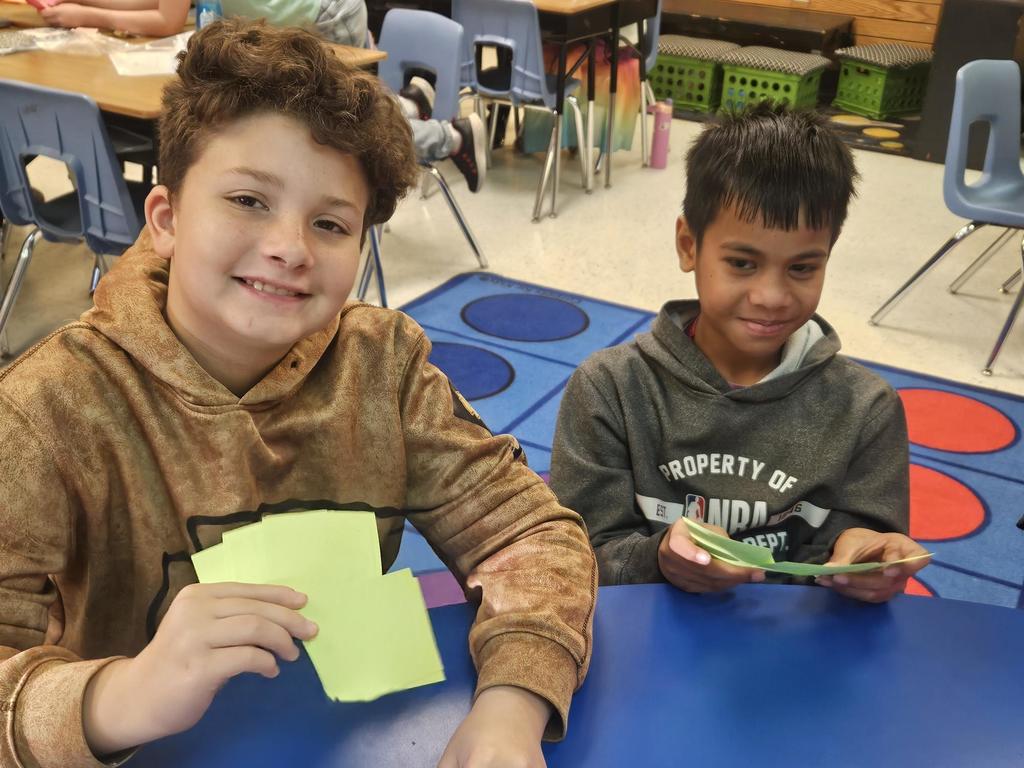 Two students playing a card game.